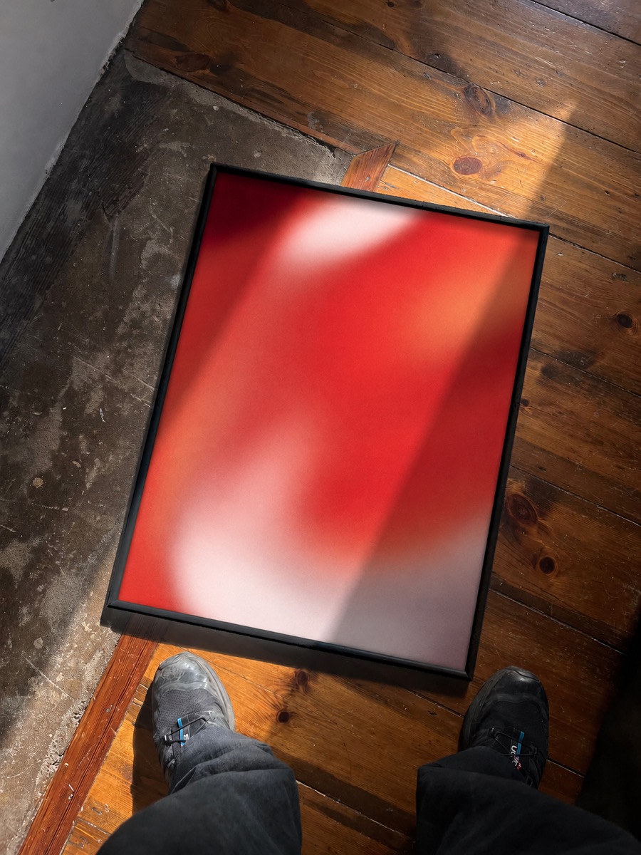 Framed poster print of a red gradient on a wooden floor